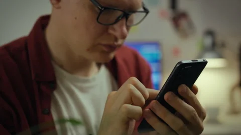 Programming. European guy is attentively immersed in virtual space in the ev Stock Footage 331297366