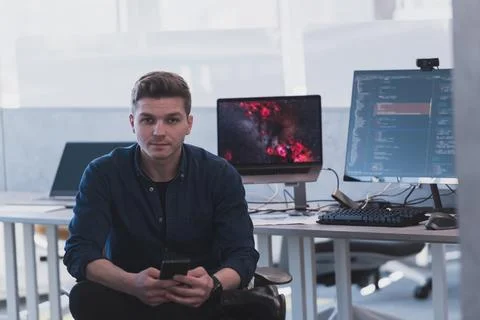 Programming. Man Working On Computer In IT Office, Sitting At Desk Writing Codes 库存照片