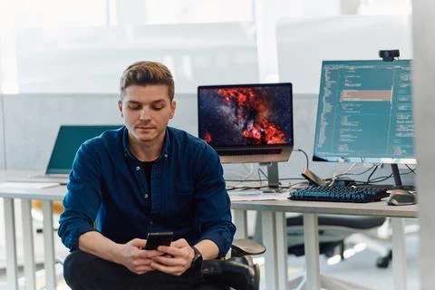 Programming. Man Working On Computer In IT Office, Sitting At Desk Writing Codes 库存照片