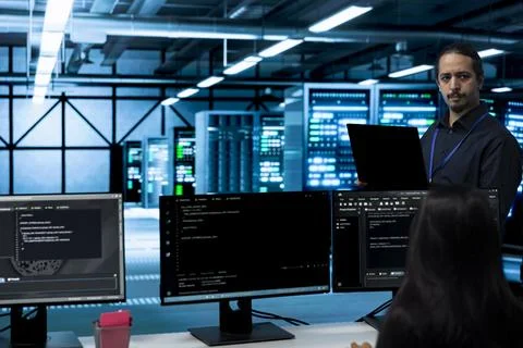 Programming, management and developer with coworker in server room Stock Photos