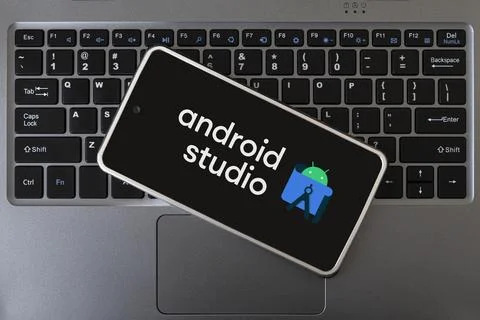 Programming mobile development, concept. Smartphone on the laptop keyboard. l Stock Photos