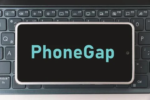 Programming for mobile development, concept. Smartphone on the laptop keybo.. Stock Photos