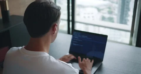 Programming professional in action, male IT programmer meticulously crafting Stock Footage 255142145