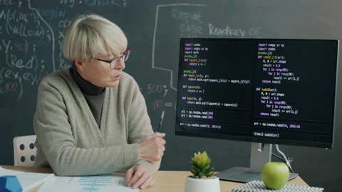 Programming school teacher explaining software coding pointing at computer Stock Footage 203868826