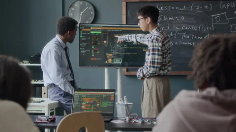 Programming Teacher and Asian Student Discussing Software Engineering in Class Stock Footage 284428745