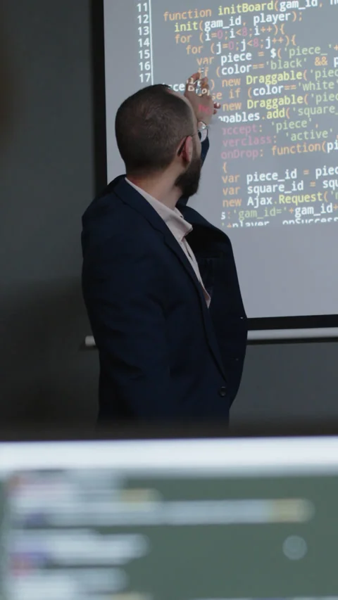 Programming Teacher Answering Students Question during Lecture Stock Footage 278584311