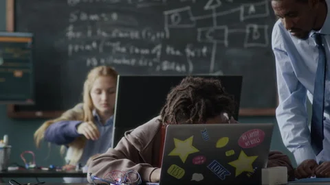 Programming Teacher Helping Teenage Student during Lesson Stock Footage 284431403