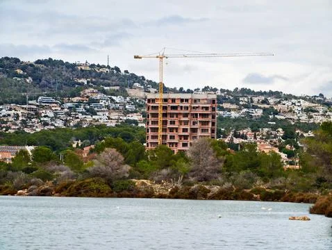 Progress In Building Practices Visible On Hillside Overlooking Calm Bay With Stock Photos