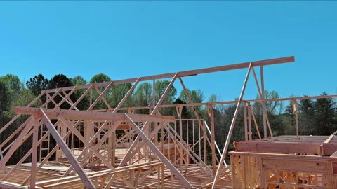In progress construction of a timber truss framed building with rafters, roof Vidéo 237848591