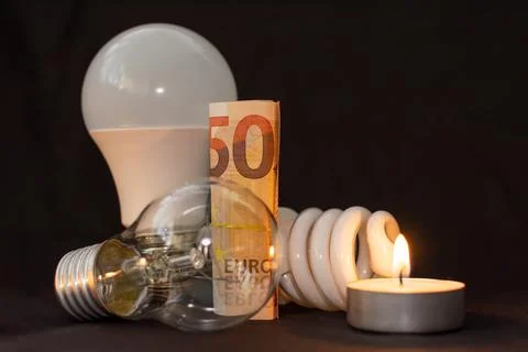 The progress of lighting from a candle to an energy-saving light bulb Stock Photos