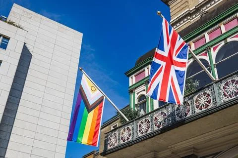 Progress Pride Flag and Union Jack on Historic UK Building Balcony Stock Photos