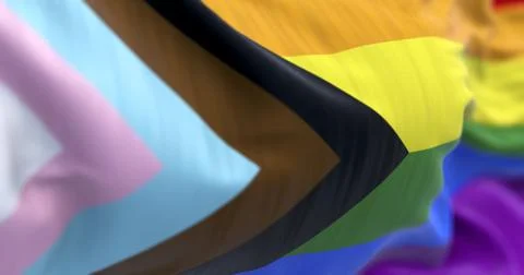 Progress Pride flag close-up with LGBTQIA+ inclusive colors and symbol of uni Illustrazione stock