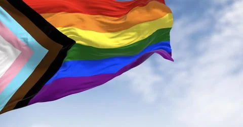 Progress Pride Flag waving against cloudy blue sky Stock Illustration