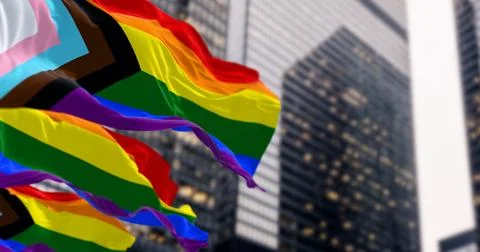 Progress Pride flag waving in the city. イラスト素材