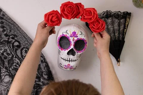 In-progress scene shows a handmade Day of the Dead sugar skull being crowned  Stock Photos