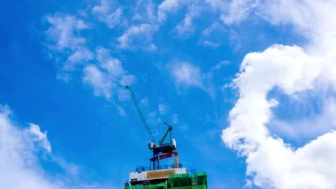 Progress Unveiled: Time-lapse of Building Construction Amidst Azure Skies Stock Footage 270495285