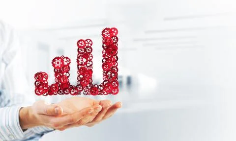 Progressing graph presented in male palms as symbol of success and improvement Stock Photos