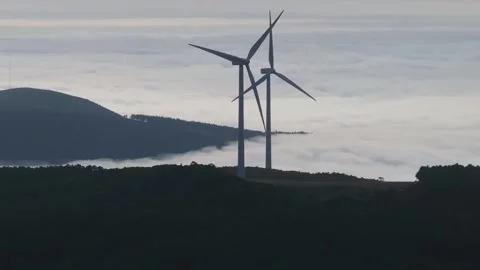 Progressive ascending orbit around two wind turbines with parallax effect Vídeo Stock 312428754