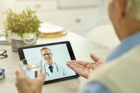 Progressive doctor controlling patient progress over a video-call Stock Photos