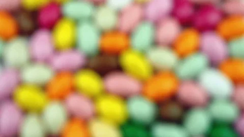 Progressive focus at floor of multicolored sugared almonds Stock Footage 70914352