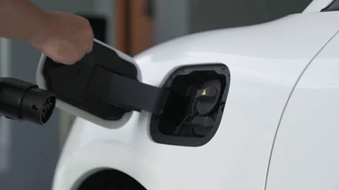 Progressive idea of charging electric vehicle via cable from charging station. Video stock 220118174