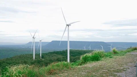 Progressive idea of using wind for electric energy by wind turbine farm. Stock Photos