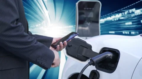 Progressive man check EV car status on smartphone, background of binary code. Stock Footage 223268040