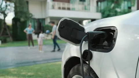 Progressive parent have returned from picking up daughter at school with EV car. Stock-Footage 221144632