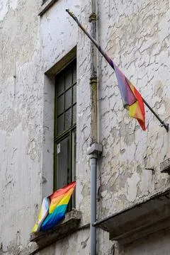 Progressive rainbow pride flags hanging from an old building in historic ci.. Stock Photos