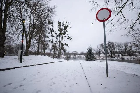 Prohibition sign set towards path leading to water in evening Фото