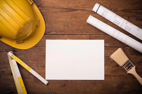 Project construction blueprints and engineering tools on wooden desk, copy sp Stock Photos