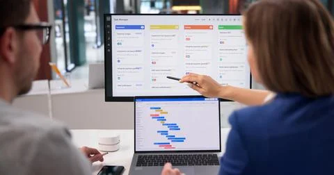 Project Coordinator Diligently Revises Event Timeline With Scrum Tool On Lapt Stock Photos