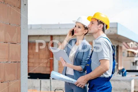 Project developer and construction worker on site using technology Stock Photos