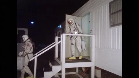 Project Gemini astronauts leaving building to board transfer van Stock Footage 263445596