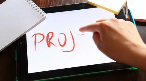 Project. Hands writing word on tablet at workplace Stock Footage 63139844