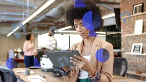 Project lead holding tablet scrolling and tapping, creating charts overlaying Stock Footage 335465998