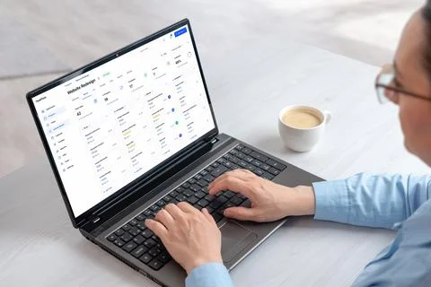 Project management dashboard displayed on laptop during remote workflow ses.. Stock Photos