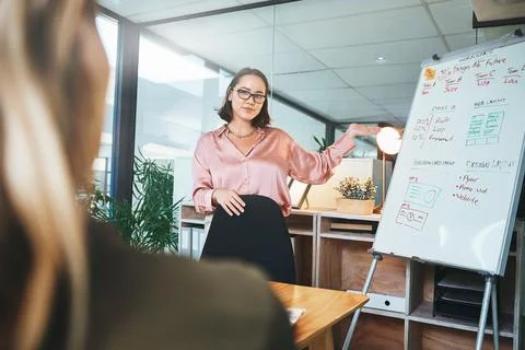 Project management pays off. a young businesswoman delivering a presentation to Stock Photos
