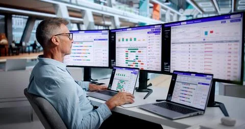 Project Manager Analyzes Utilization Dashboard On Laptop To Improve Project E Stock Photos