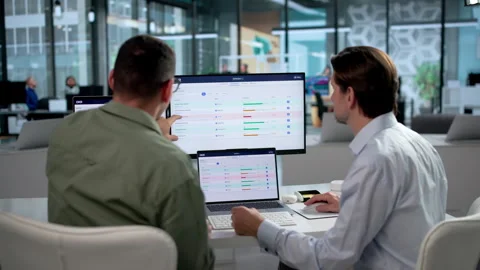 Project Manager And Analyst Discuss OKR Strategy Using Laptop Stock Footage 347295373