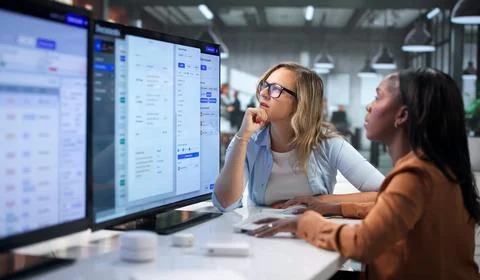 Project Manager And Assistant Collaborate On Digital Document Workflow System Stock Photos