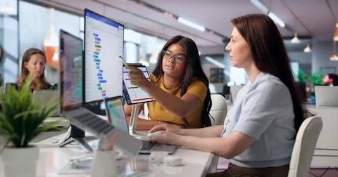 Project Manager And Assistant Discuss Schedule On Laptop While Planning Tasks Stock Photos