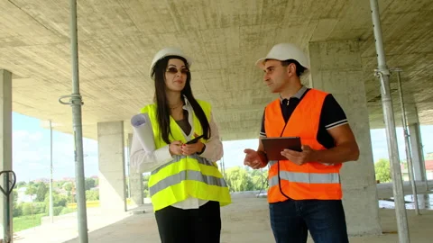 Project manager and contractor walk through unfinished building Stock Footage 317619524