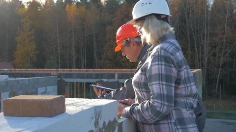 Project manager and engineer discussing new estate project on construction site Stock Footage 315585752
