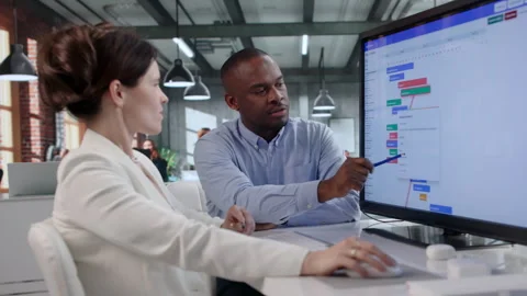Project Manager And Team Member Review Gantt Chart Progress Stock Footage 343882654