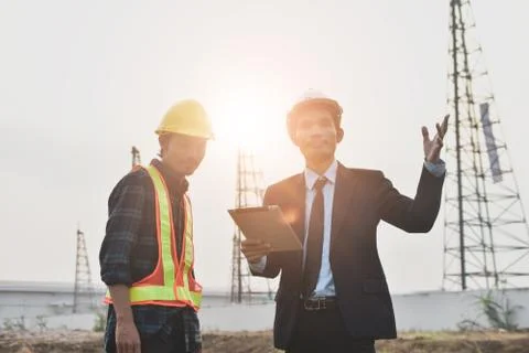 Project manager holding tablet communication with Construction Engineering  f Stock Photos