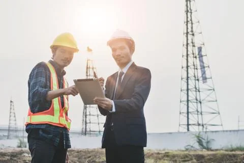 Project manager holding tablet communication with Construction Engineering  f Stock Photos