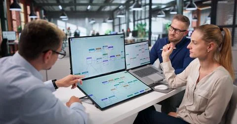 Project Manager Leads Diverse Team Using Automation Software For Efficient Wo Stock Photos