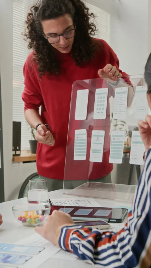 Project Manager Listening to Designer Presenting Wireframe Concepts at Meeting Stock Footage 327903932