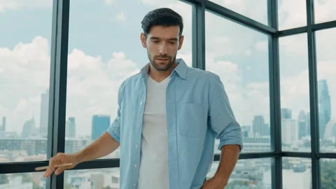 Project manager looking at city view while looking at house model. Tracery Stock Footage 264079361